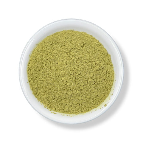 A bowl filled with green Avocado Leaf Powder.