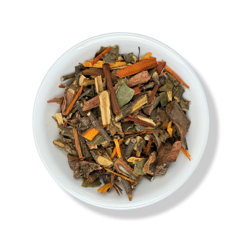 A bowl of loose leaf tea with various herbs and spices visible