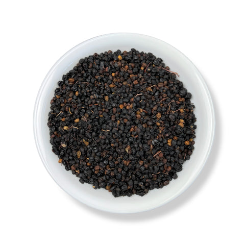 A bowl of whole, dried elderberries.