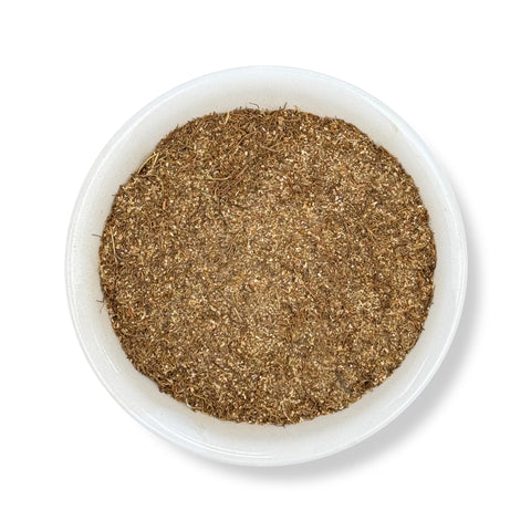 A bowl filled with fine-cut Mandrake root, a herbal product used for its mystical and traditional properties.