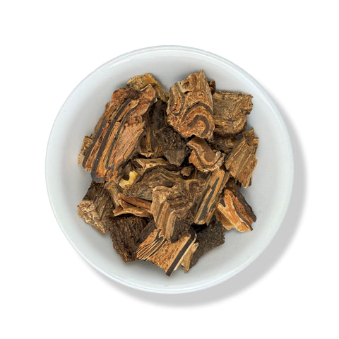 A bowl containing dried pieces of Palo de Vibora (snake herb) against a white background