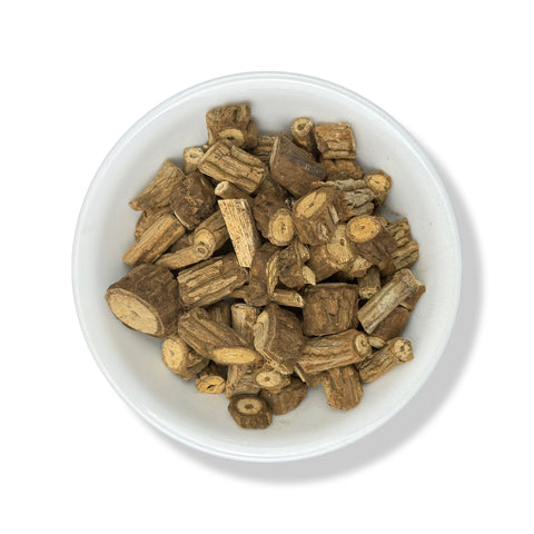 A bowl of dried Mikania glomerata roots, also known as Palo Guaco, against a white background.