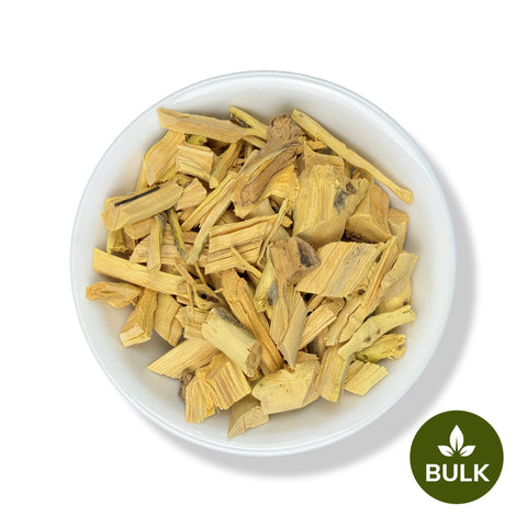 White bowl filled with dried Quassia wood cut pieces, labeled as bulk with a green badge in the corner.