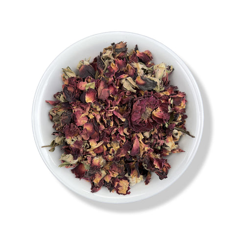 A bowl filled with dried red rose buds.