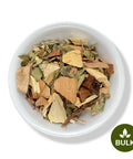 A bowl of dried herbal tea ingredients including roots and leaves.