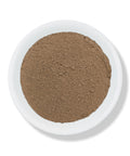 A white bowl filled with finely ground brown aloe vera powder on a white background.