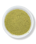 A bowl filled with green Avocado Leaf Powder.
