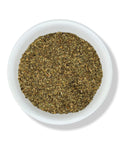 A bowl filled with dried basil leaves.