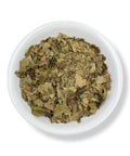 A bowl filled with dried black walnut leaves.