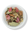A bowl of loose leaf Bronquios Tea with various dried herbs and flowers visible.
