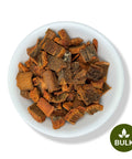 A white bowl filled with dried Cinchona bark pieces on a plain background, with a 'BULK' label in the lower right corner.