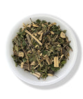 A bowl of dried herbal tea leaves and spices.