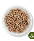A white bowl filled with brown capsules, with a green button labeled 'BULK' on the right side.