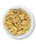 A bowl filled with Quassia chips, which are light brown to yellow in color.