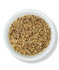 A bowl of cut and sifted dandelion root pieces.
