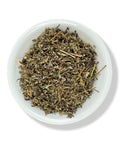 A bowl filled with dried Mugwort herb leaves.