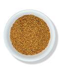 A bowl filled with whole fenugreek seeds.