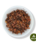 Bowl filled with loose dried Flor de Tila flowers in bulk packaging, showing reddish-brown herbal petals