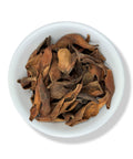 A bowl filled with dried, brown magnolia flowers.