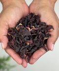 A handful of dried hibiscus flowers, typically used for making tea or in culinary dishes.