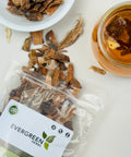 Evergreen Herbs Cuachalalate dried pieces spilling from a pouch, with a bowl of the herb and a jar of brewed herbal tea.