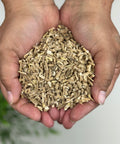 Hands holding cut and sifted Ashwagandha Root.
