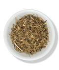 A bowl full of dried Hierba Del Sapo (Mexican Thistle) herbs against a white background.