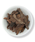 A bowl filled with dried Tepezcohuite tree bark pieces.