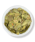 A bowl filled with dried Uva Ursi leaves.