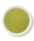 A bowl of green Moringa Leaf Powder on a white background.