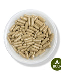 A white bowl filled with beige capsules, with a green button labeled 'BULK' and a leaf symbol indicating the product is a bulk supplement.