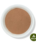 A white bowl filled with brown powder, labeled with a 'BULK' sticker on the bottom right.
