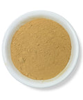 A bowl filled with ginger root powder against a white background.