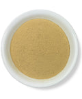 A bowl of Muira Puama Powder against a white background.