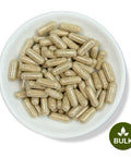 A bowl full of brown capsules with a 'BULK' label at the bottom