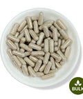 A white plate filled with brown capsules, with a 'BULK' label at the bottom right corner.