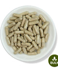 A white bowl filled with brown capsules, with a 'BULK' label at the bottom right corner.