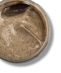 Open jar of a creamy beige Tepezcohuite herbal paste with small dark specks.