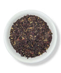 A bowl of Irish Sea Moss Flakes on a white background.
