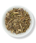 A bowl of dried Lemon Balm leaves, which are used for their soothing and stress-relieving properties.
