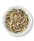 A bowl filled with dried lemongrass pieces.