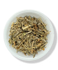 A bowl filled with dried Horehound leaves and stems, also known as Marrubium vulgare, on a white background.