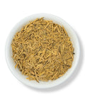 A bowl filled with Muira Puama herb, which appears dry and shredded.