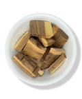 A bowl containing dried pieces of Palo Azul (Kidney Wood) against a white background