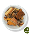 A bowl of dried Palo Brazil roots, primarily in shades of brown and red, with a label indicating 'Bulk'.