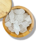 A wooden bowl containing crystalline white alum stone pieces.