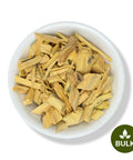 White bowl filled with dried Quassia wood cut pieces, labeled as bulk with a green badge in the corner.