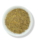 Dried rosemary leaves in a white bowl.