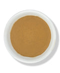 A bowl of black sarsaparilla powder on a white background.