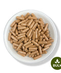 A white bowl filled with brown capsules, with a green leaf logo indicating the product is a bulk item.
